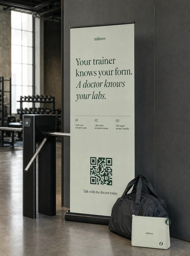 A sage roll-up banner by a gym turnstile