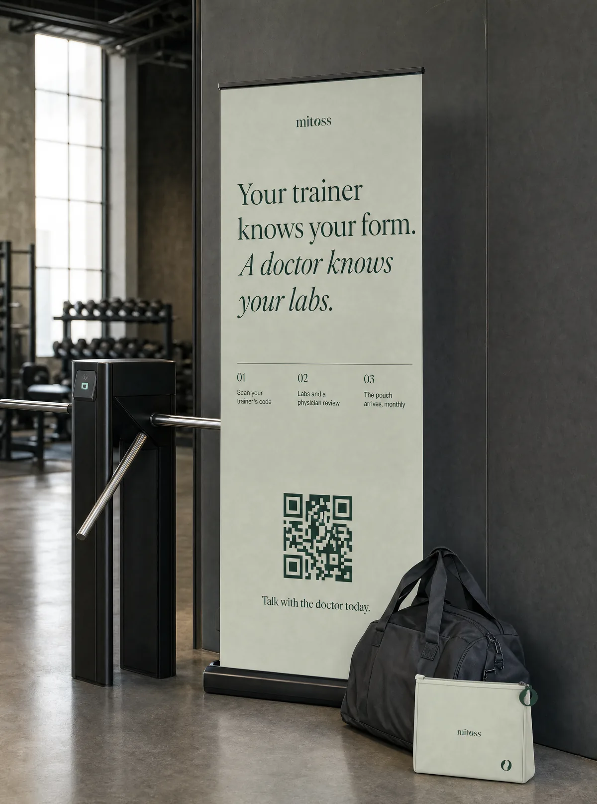 A sage roll-up banner by a gym turnstile: Your trainer knows your form. A doctor knows your labs.