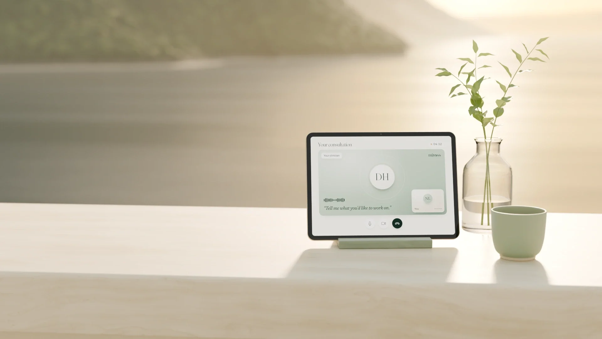 A tablet on a stand showing a live video visit with a clinician